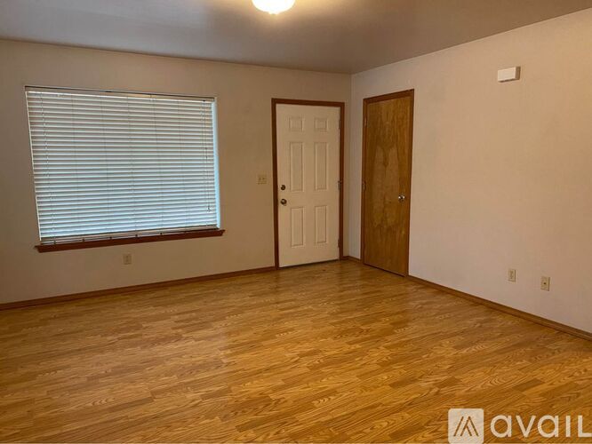 A room with wooden floors and a white door.