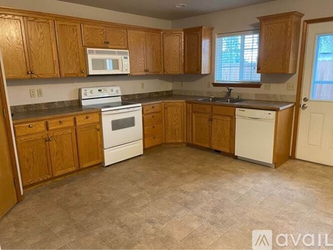 A kitchen with wooden cabinets and a white oven.