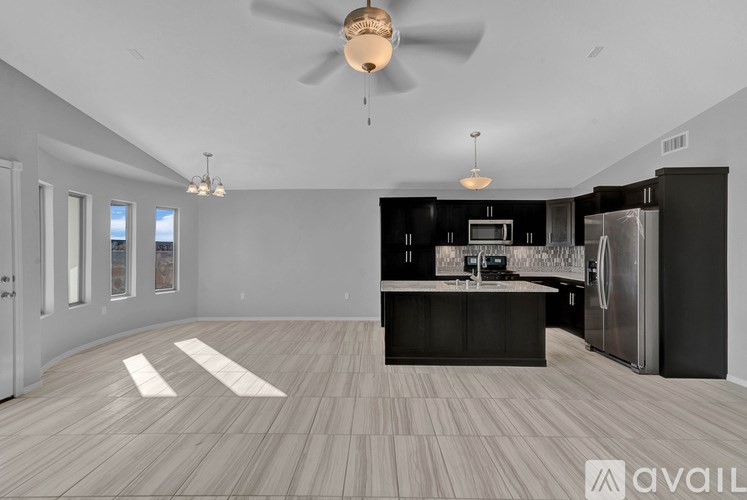 A spacious kitchen with a refrigerator, microwave, and oven.