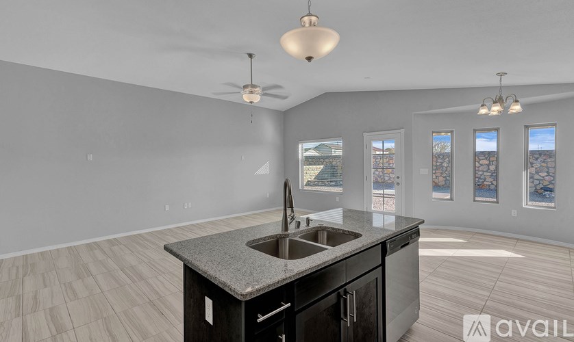 A kitchen with a granite countertop and a sink is available for purchase.