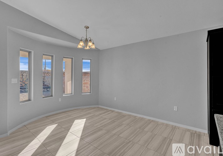 A room with a wooden floor and a chandelier.