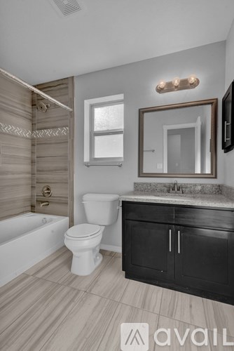 A bathroom with a toilet, sink, and mirror.