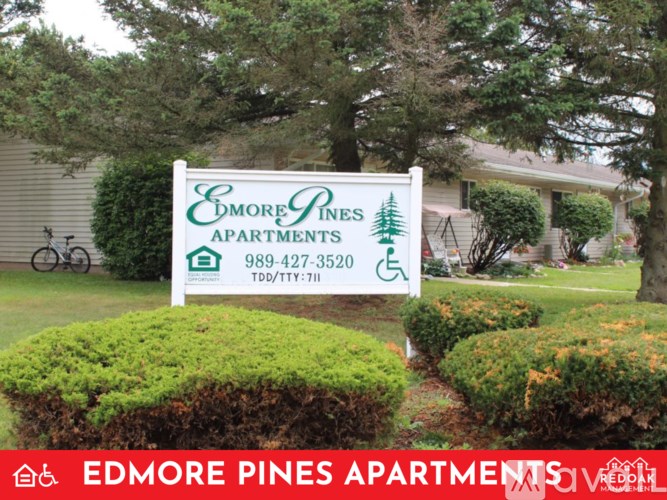 A sign for Edmore Pines Apartments is displayed in front of a building.
