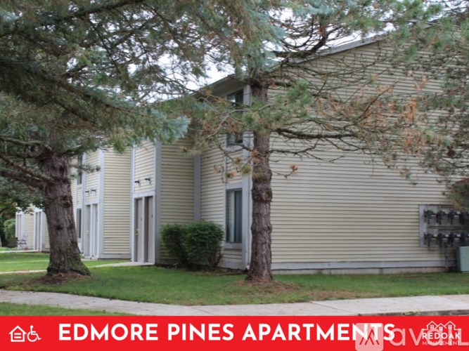 A building with the words Edmore Pines Apartments on it.