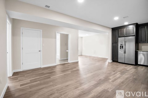 A spacious kitchen with a refrigerator, cabinets, and a dishwasher is available for rent.