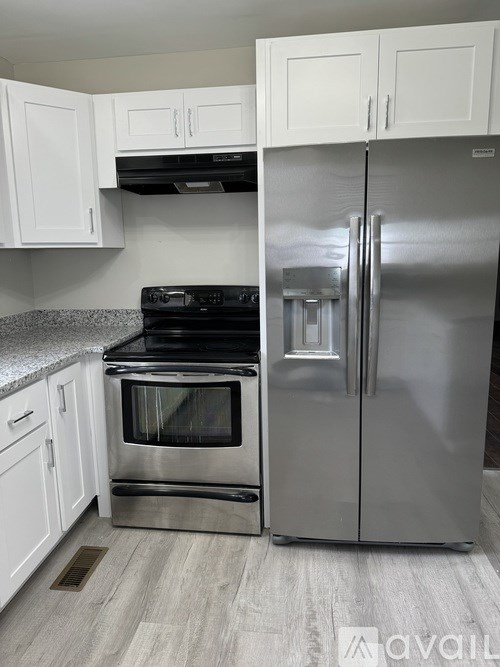 A kitchen with a stainless steel refrigerator and oven.