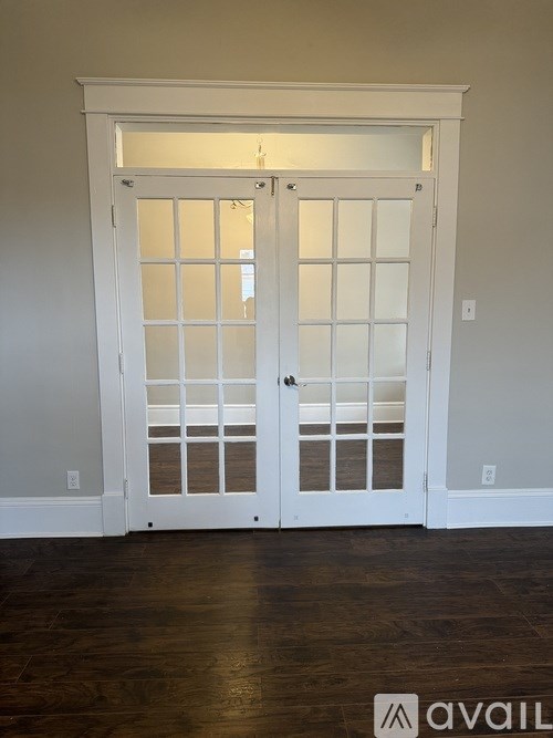 A white door with a glass panel and a handle.
