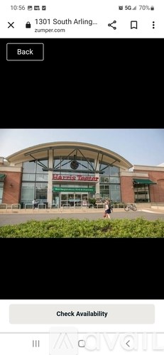 A person is walking in front of a building with a sign that reads "1301 South Arlington.".
