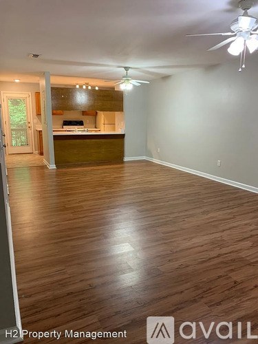 A room with wooden flooring and a ceiling fan.