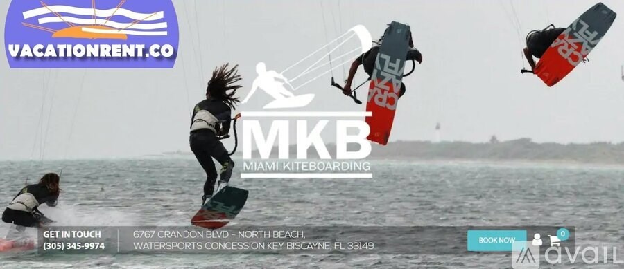 A kiteboarding advertisement with a person in the air and contact information for Vacation Rentals.
