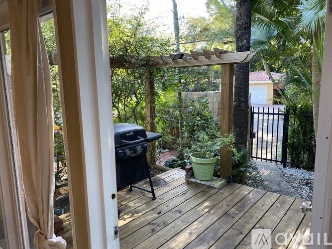 A patio with a grill and a table.