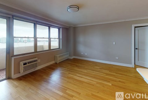 A room with wooden floors and a window seat.
