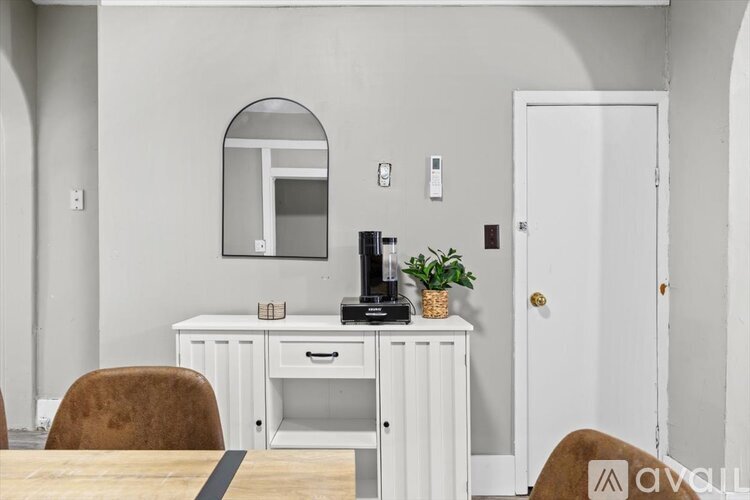 A room with a carpeted floor and a door leading to another room.