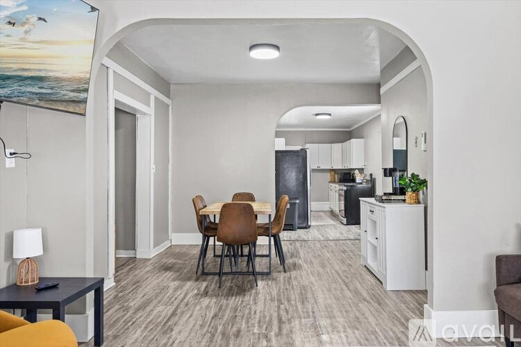 A kitchen with white cabinets and a black countertop.
