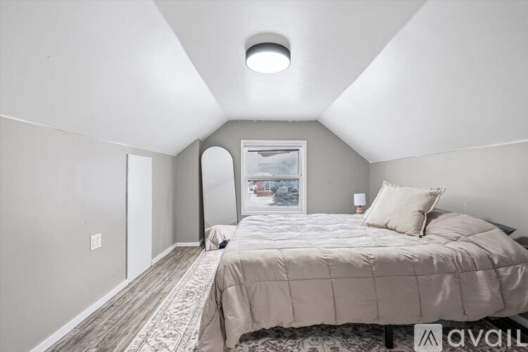 A room with a grey floor and a white door.