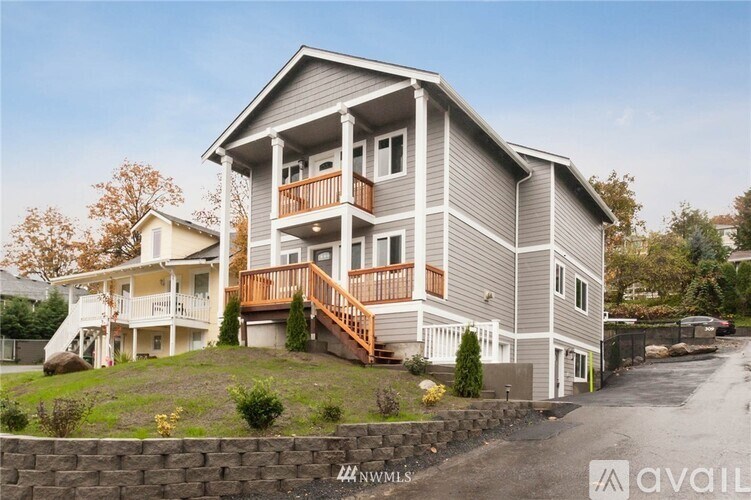 A two-story house with a balcony on the second floor.