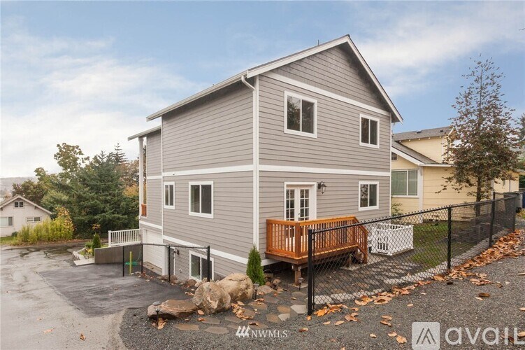 A house with a grey exterior and a black fence.