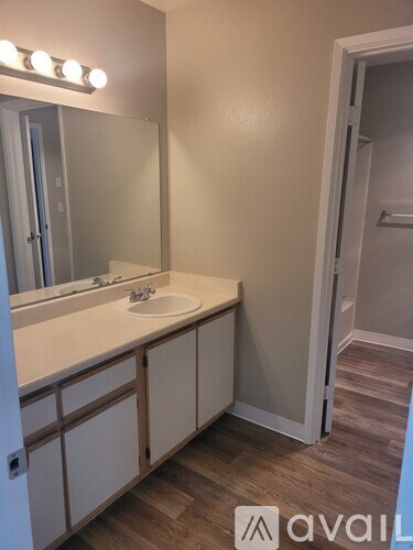 A bathroom with a sink and mirror.