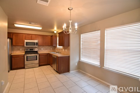 A kitchen with wooden cabinets and a stainless steel oven.