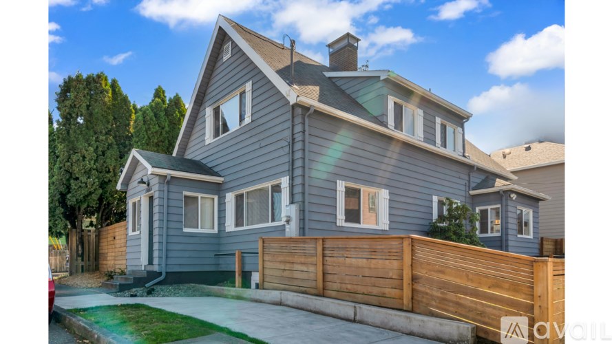 A house with a grey exterior and a wooden fence.