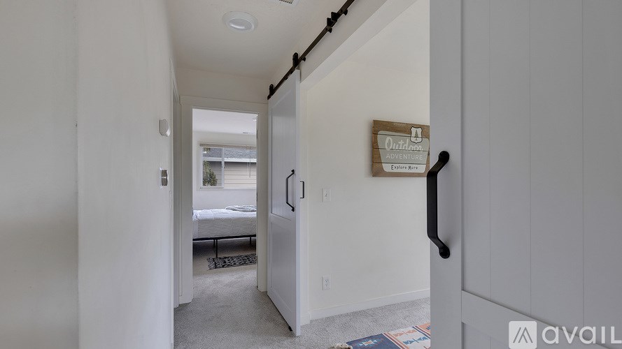 A room with a door and a sign on the wall.