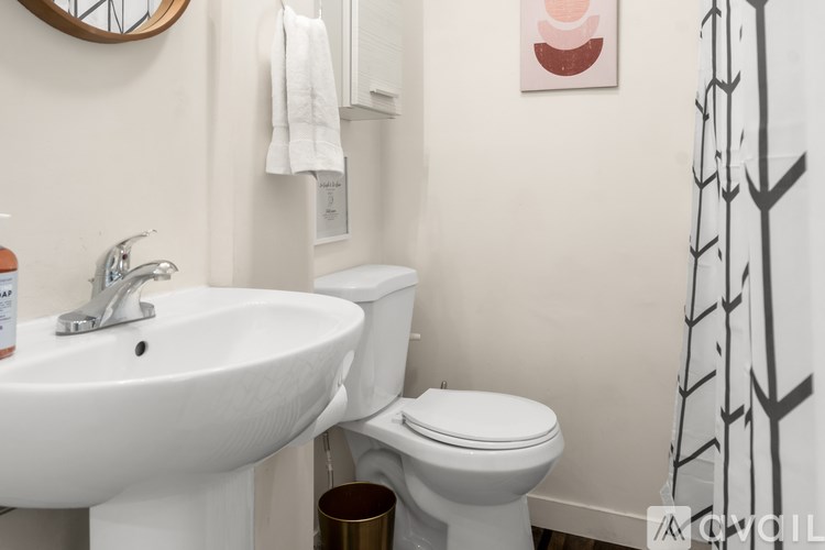 A white sink and toilet in a bathroom.