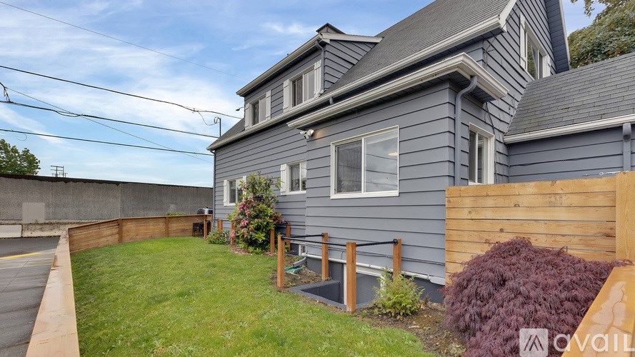 A house with a grey exterior and a wooden fence.