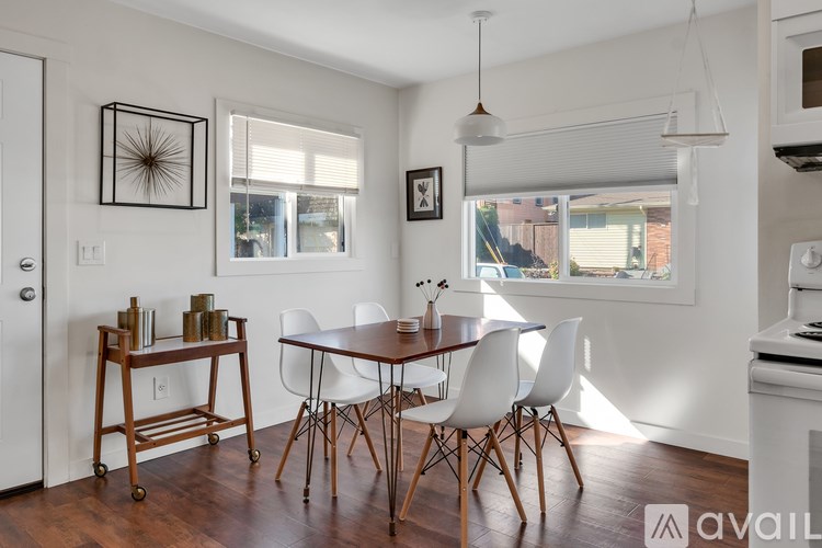 A kitchen with a white table and chairs.