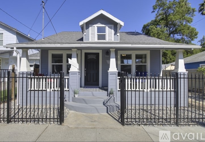 A house with a black gate in front.