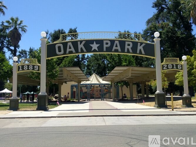 A sign for Oak Park stands in front of a covered walkway.