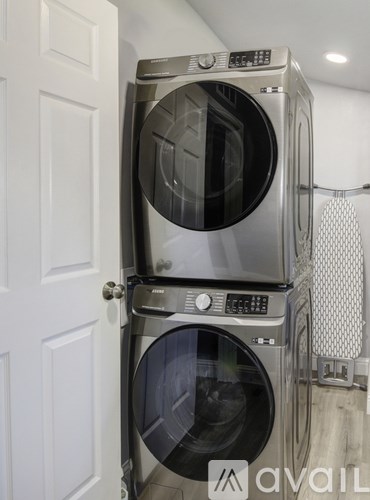 A stack of two washing machines in a laundry room.