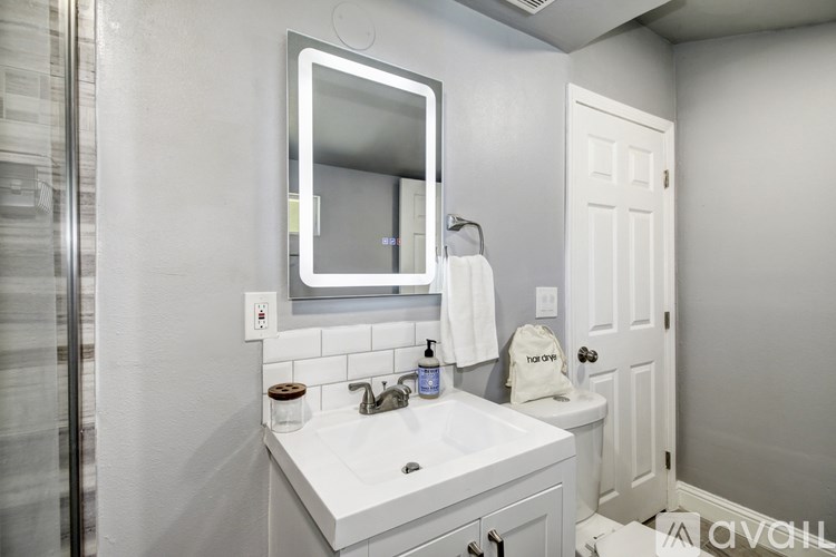 A bathroom with a white sink and a mirror above it.