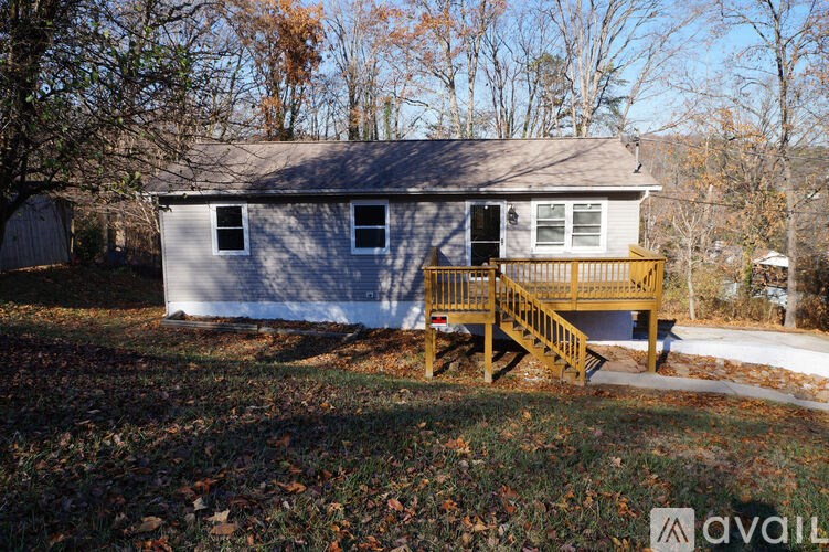 A house with a grey roof and a wooden deck.