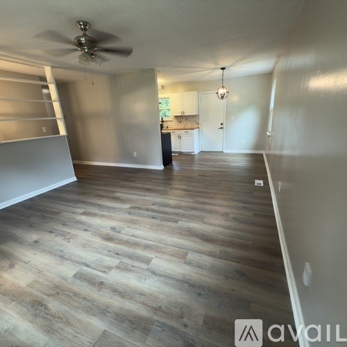 A kitchen with black appliances and white cabinets.