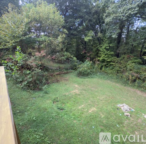A living room with a white couch and a glass table.