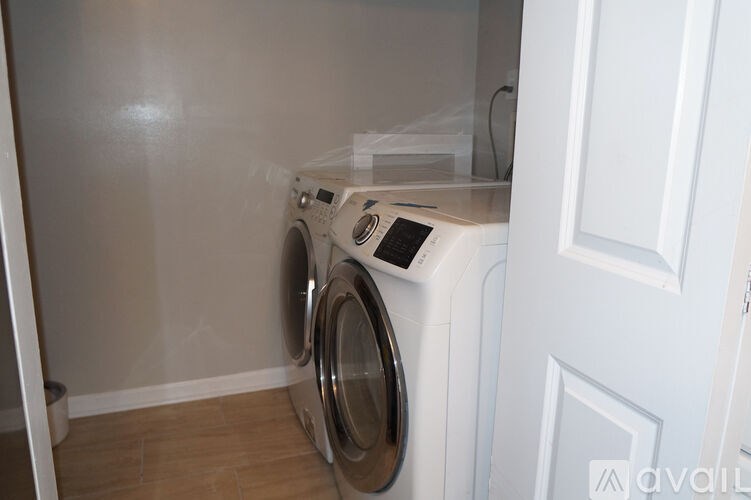 A washing machine is sitting in a laundry room.