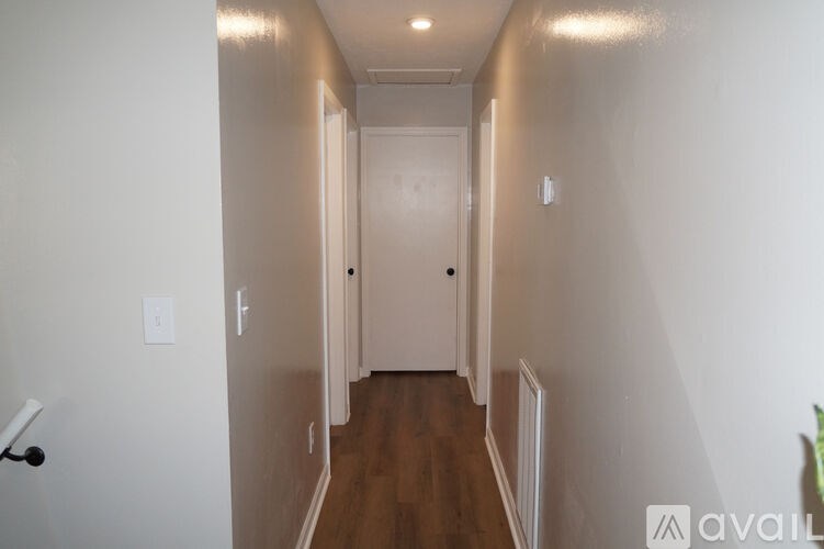 A long hallway with a door at the end.