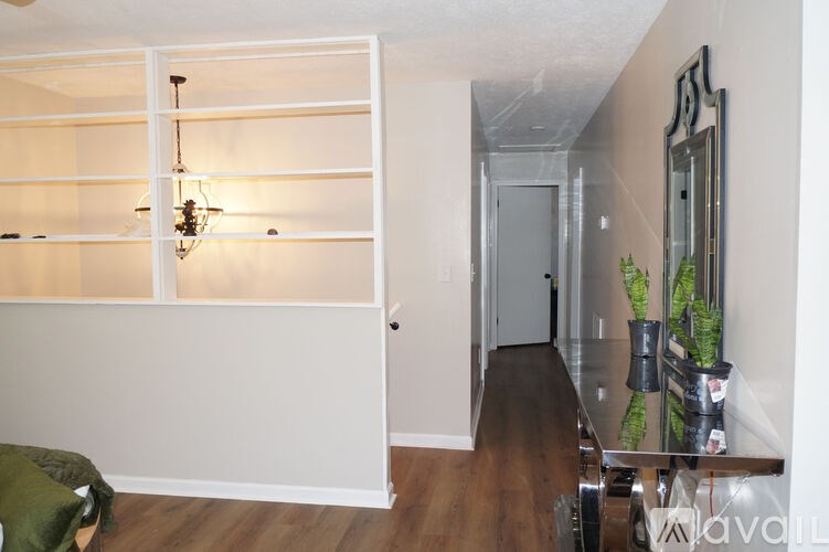 A living room with a white couch and a glass table.