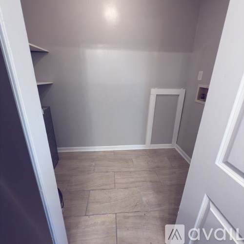 A house with a deck and a driveway in front.