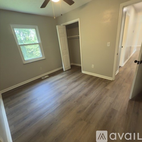 A living room with a brown leather chair and a white couch.