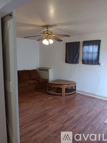 A living room with a brown sofa and a wooden coffee table.