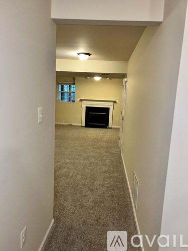 A room with a fireplace and a window.