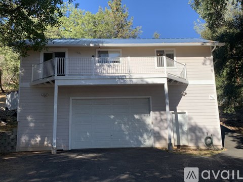A two-story house with a balcony and a garage.