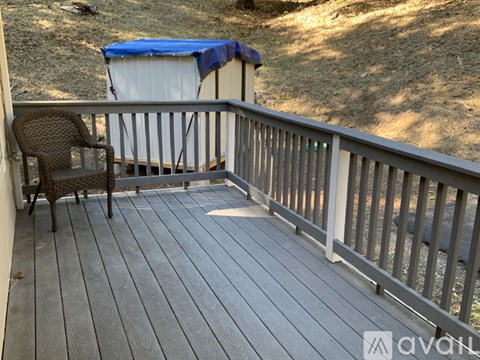 A patio with a chair and a table.