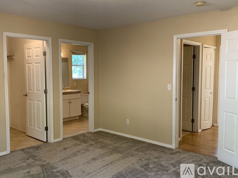 A room with three open doors leading to other rooms.