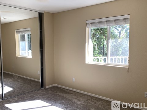 A room with a window and a sliding glass door.