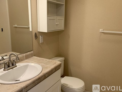 A bathroom with a sink, toilet, and medicine cabinet.