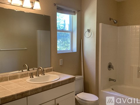 A bathroom with a sink, toilet, and bathtub.