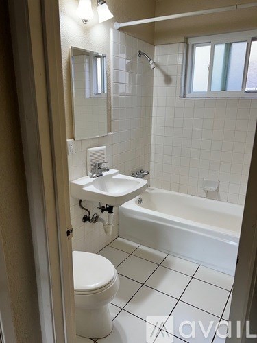 A white bathroom with a sink, toilet, and bathtub.