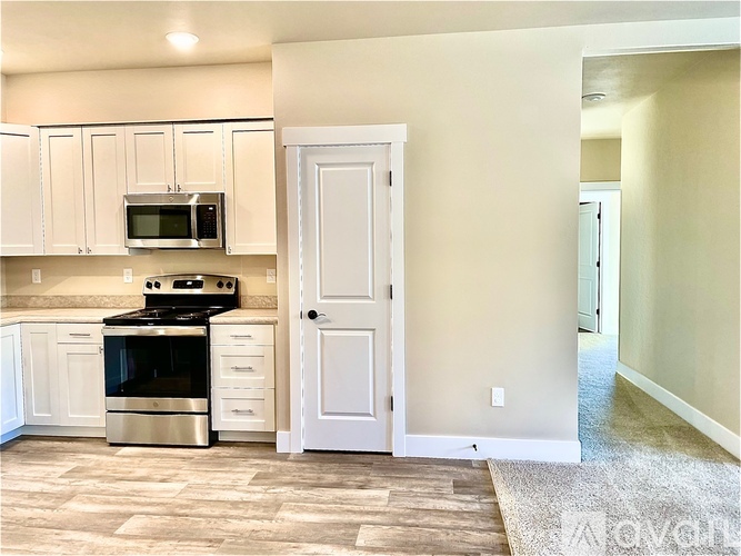 A kitchen with a stove, oven, and microwave.